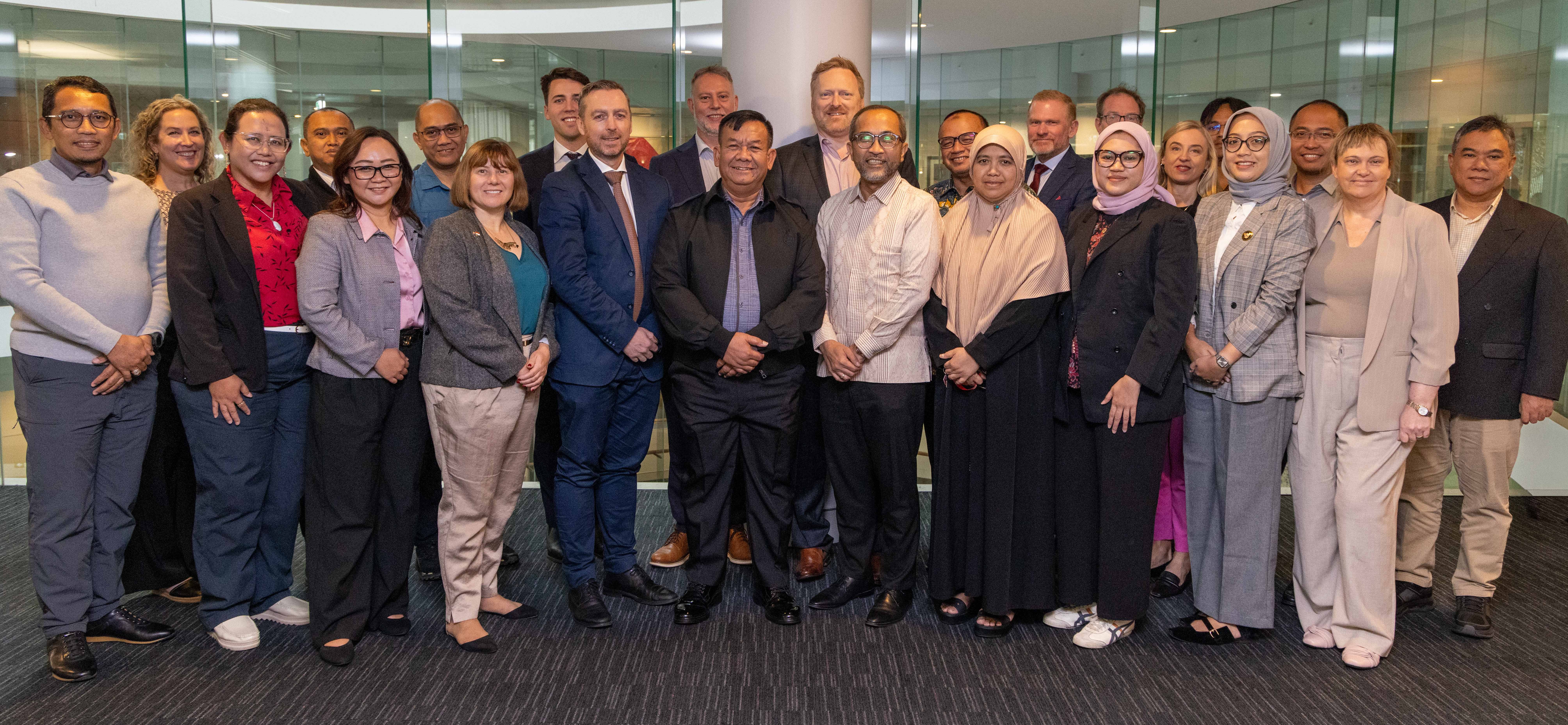 A formal group photo of representatives from the Government of Indonesia and their Australian counterparts in a study tour on subsea telecommunication cables .jpg .jpg