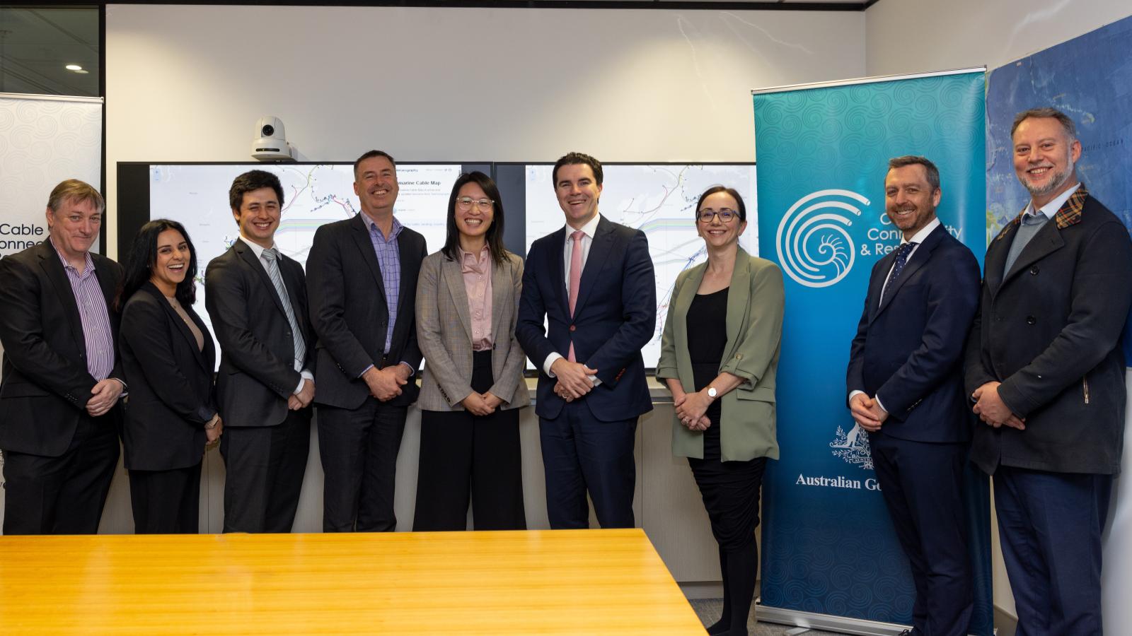 Government officials and the Cable Connectivity and Resilience Centre team standing together beside CCRC banners during the launch of the Centre.