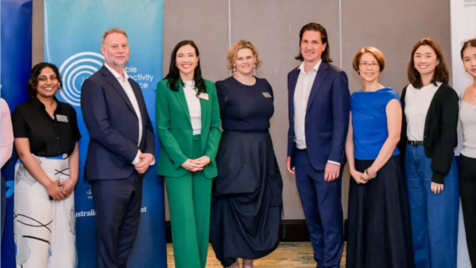 Participants from Indo-Pacific governments, industry and technical organisations standing together beside a Cable Connectivity and Resilience Centre banner during the regional cable futures workshops.