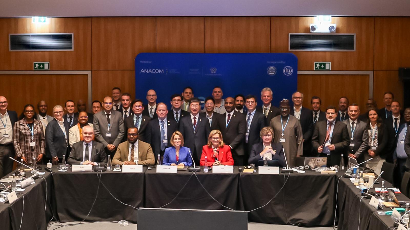 A formal group photo of attendees sitting and standing around a board table at the Second International Subsea Cable Resilience Summit, held in February 2026, in Portugal.