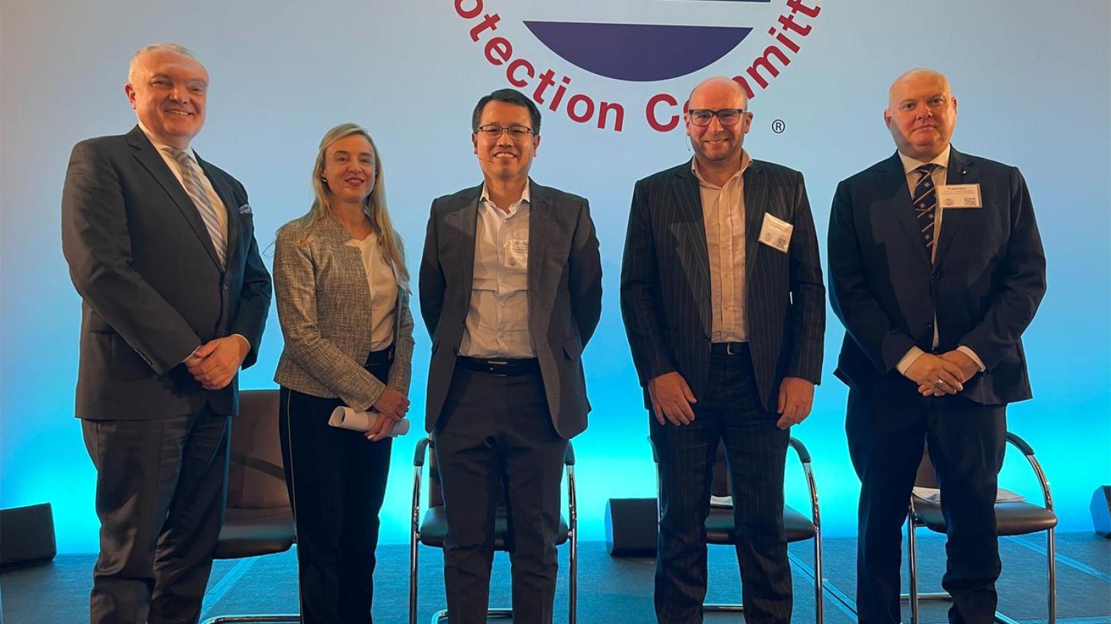 A group of panel speakers standing on stage at ICCC, including Kent Bressie, Dr Fabrizio Bozzato, Dr Franck Chevalier, Nadia Krivetz and Marcus Tong, in front of a conference backdrop.